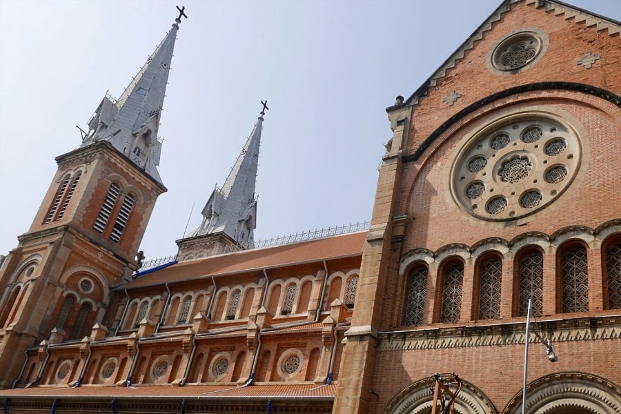 The signature of the Notre Dame Cathedral's architecture is the red brick walls